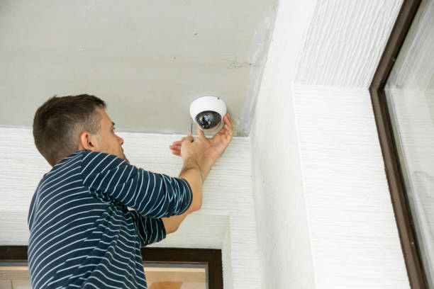 Man installing a security camera.
